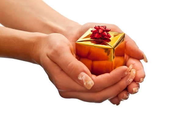 Yellow gift box in woman's hand — Stock Photo, Image