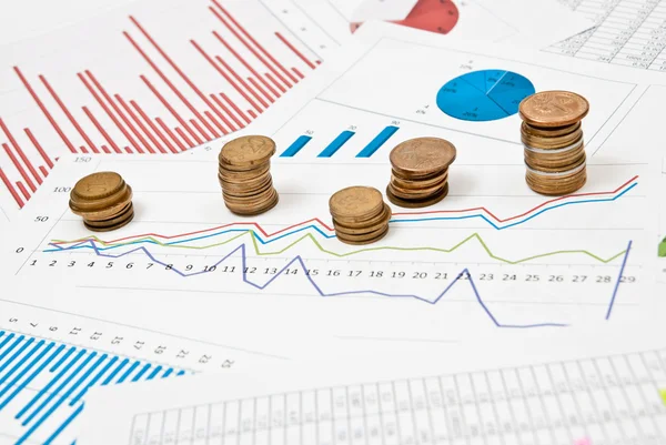 Coins and charts — Stock Photo, Image