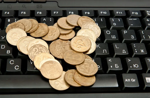 Coins on keyboard — Stock Photo, Image