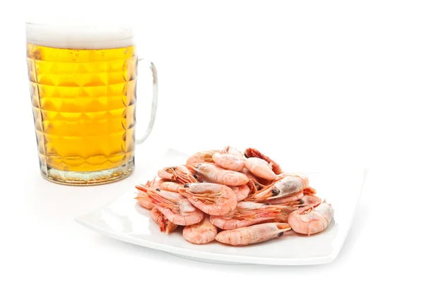 stock image Fresh, cold beer in glass and fried shrimps on plate. Isolated on white