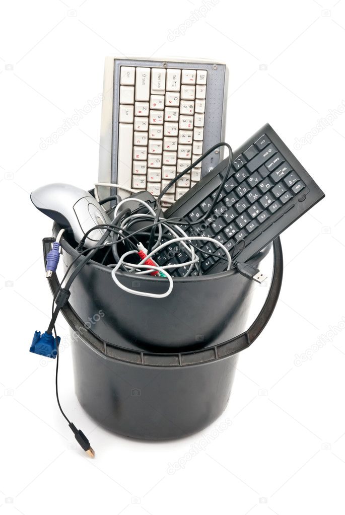 Full trash of used computer hardware. Keyboards, cables... Isolated on white