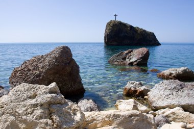 Beauty sea landscape, with cross on the rock.