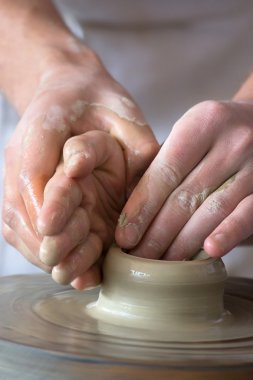 Potter`s hands making new pot. clipart