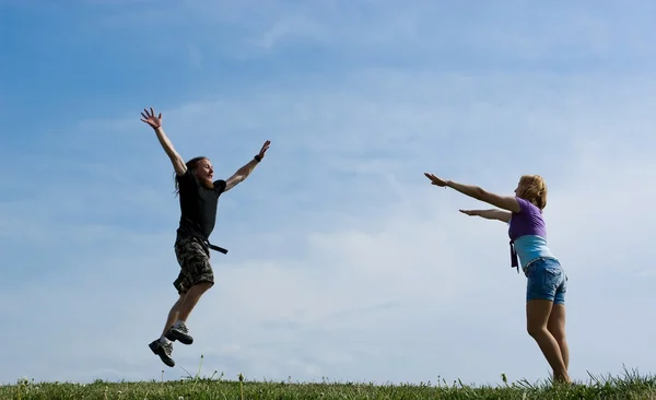 Rapaz feliz pulando para menina . — Fotografia de Stock