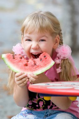 Cute girl eating watermelon. clipart