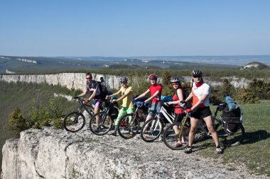 A group of five adults on bicycles in the countryside. Everyone can ride a bike. Everyone who rides a bike is my friend. clipart