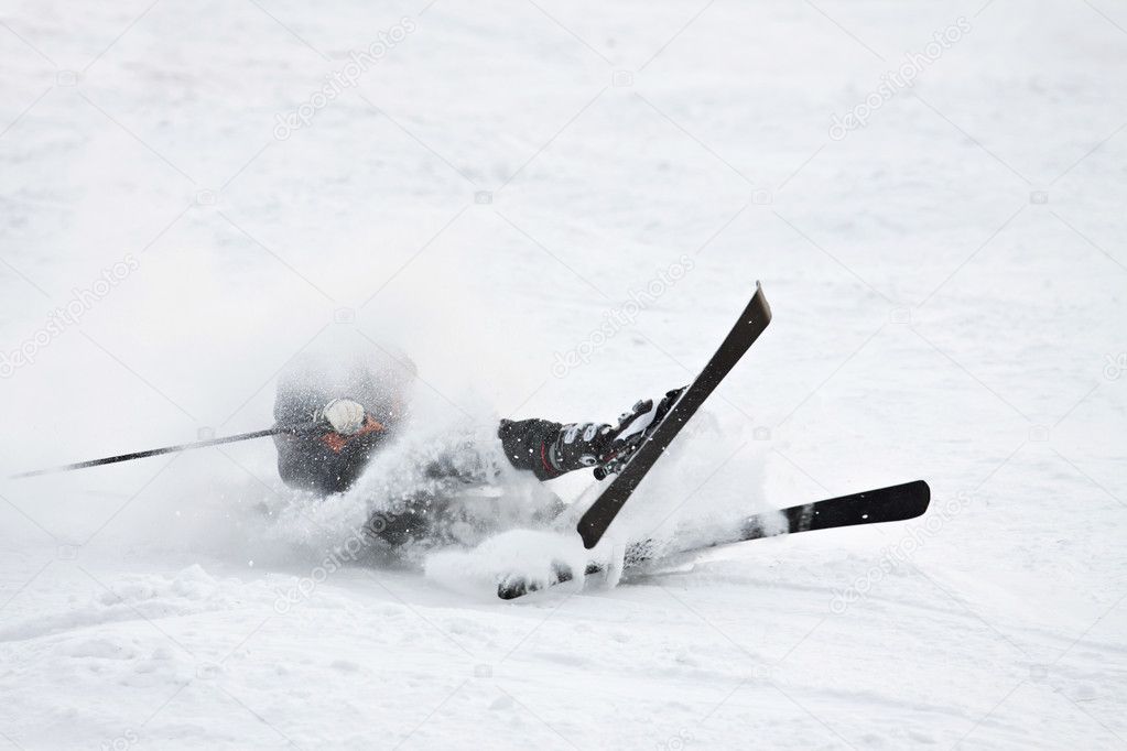 Man riding on skis fall down, he could break something.