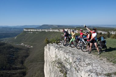 A group of five adults on bicycles in the countryside. Everyone can ride a bike. Everyone who rides a bike is my friend. clipart