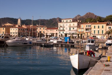 Fisherman Cleaning Fishnets In Porto Azzurro, Elba Island clipart