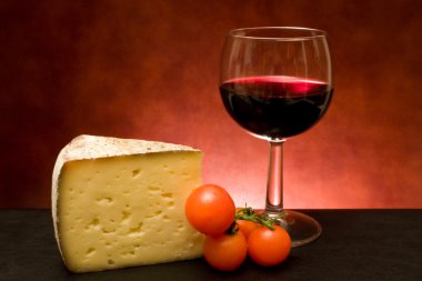 Food And Drinks - Still life with cheese and red wine. clipart