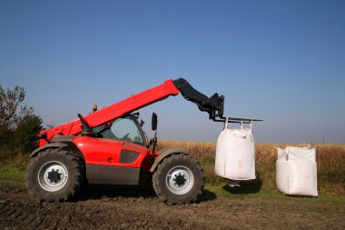 Agricultural machinery with bag of weath seeds clipart