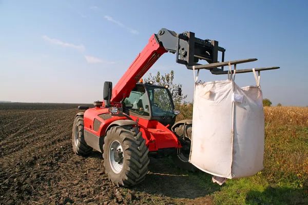 Agricultural machinery with bag of weath seeds — Stock Photo, Image