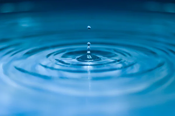 Droplets falling in blue water — Stock Photo © nejron #4804418