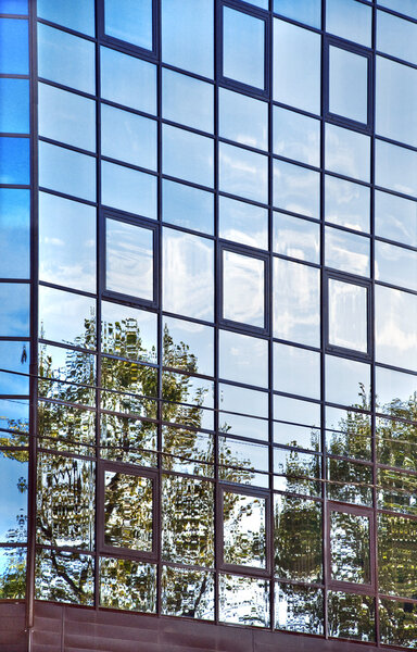 Sky reflections in the glass wall. modern architecture