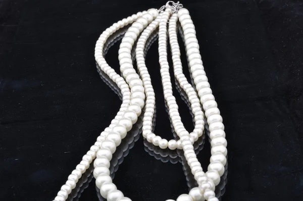 stock image Pearl necklace on black background