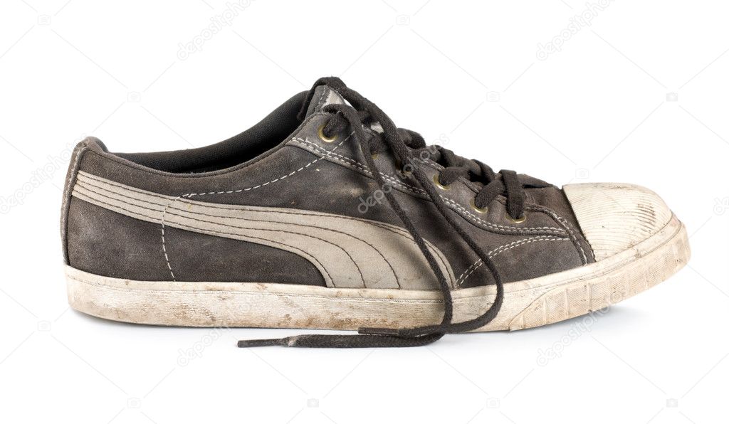 Old dirty sneakers isolated on white background