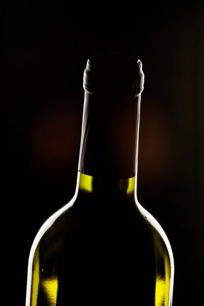Láhev vína na tmavém pozadí — Stock fotografie