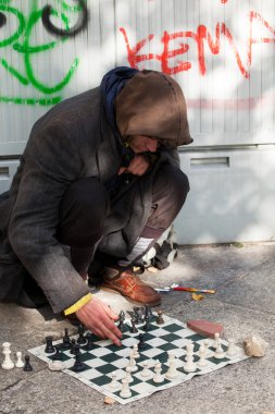 Homeless chess master playing chess clipart