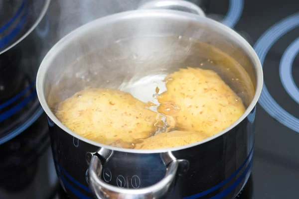 stock image Potato boiling in water