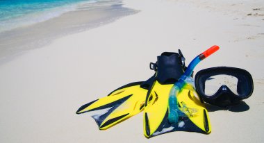 Diving Mask with fins on beach clipart