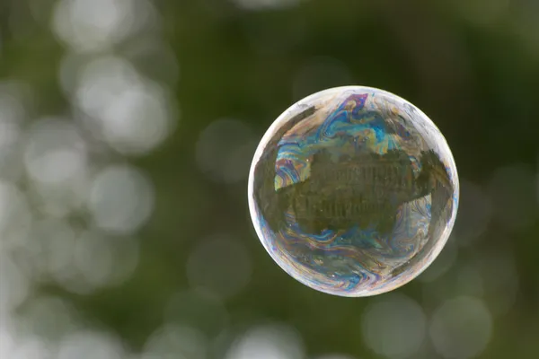 Soap bubble on green background — Stock Photo, Image