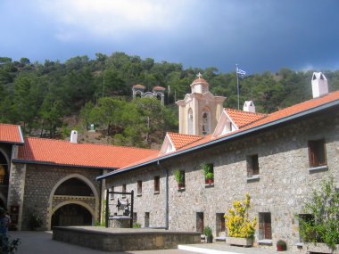 Cyprus monastery courtyard Kikos with well clipart