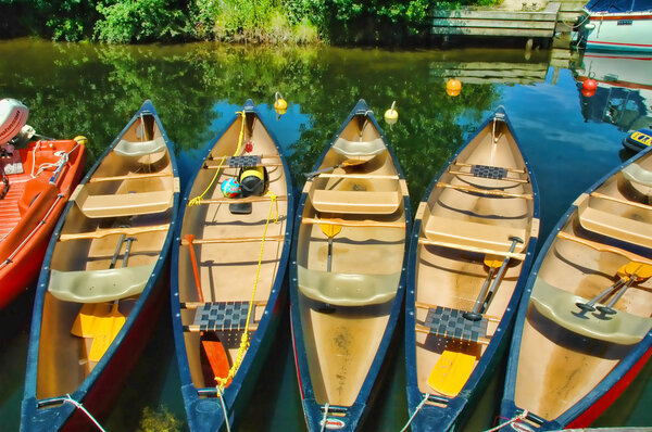 Colorful canoes all lined up and ready to go
