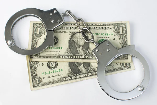Close-up handcuffs and money — Stock Photo, Image