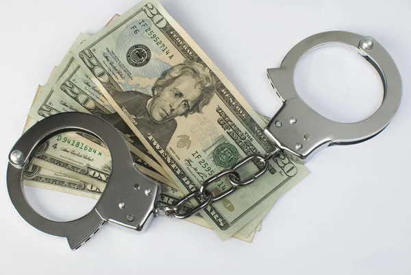 Close-up handcuffs and money — Stock Photo, Image