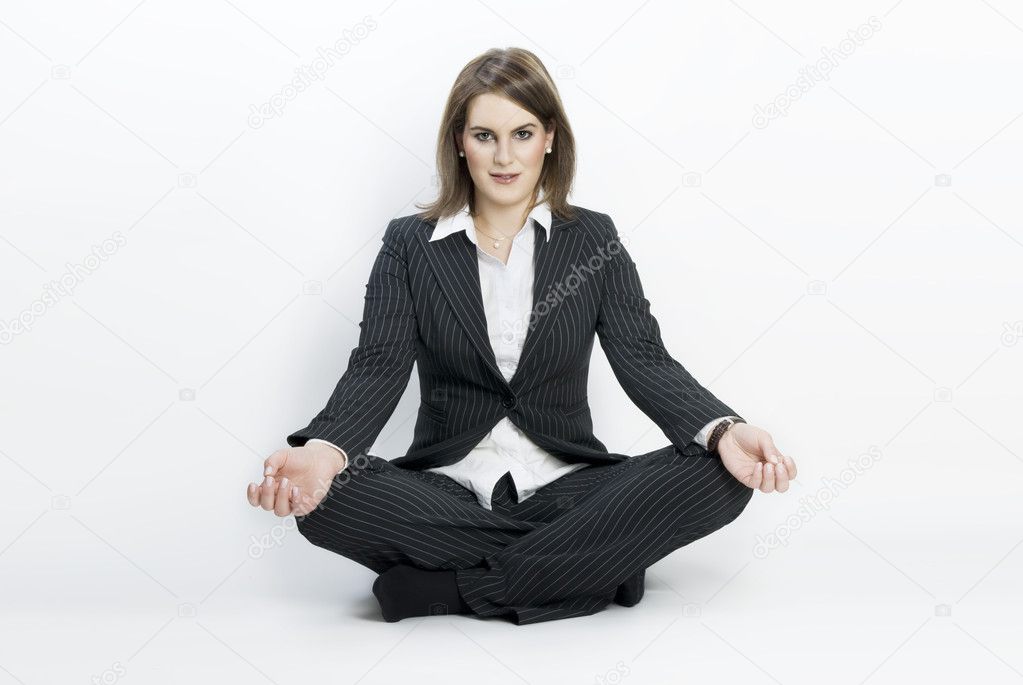 Young businesswoman sitting in lotus position.