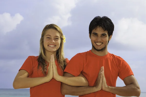Paar mediteren op het strand — Stockfoto