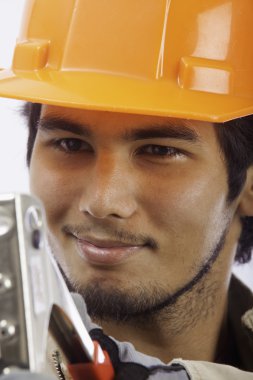 Hard hat worker with a rivet tool clipart