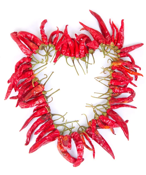 stock image Heart shaped chaplet of dried chilies over the white background