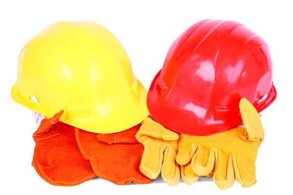 Dvě helmy přes dva páry ochranných rukavic — Stock fotografie