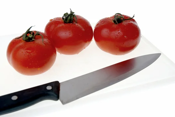 stock image Cutting board with a knife and tomato