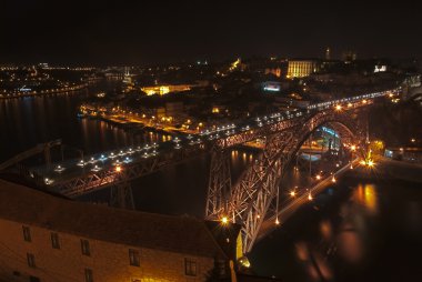 Dom Luis Iron Bridge in Porto illuminated at dusk, Portugal. clipart