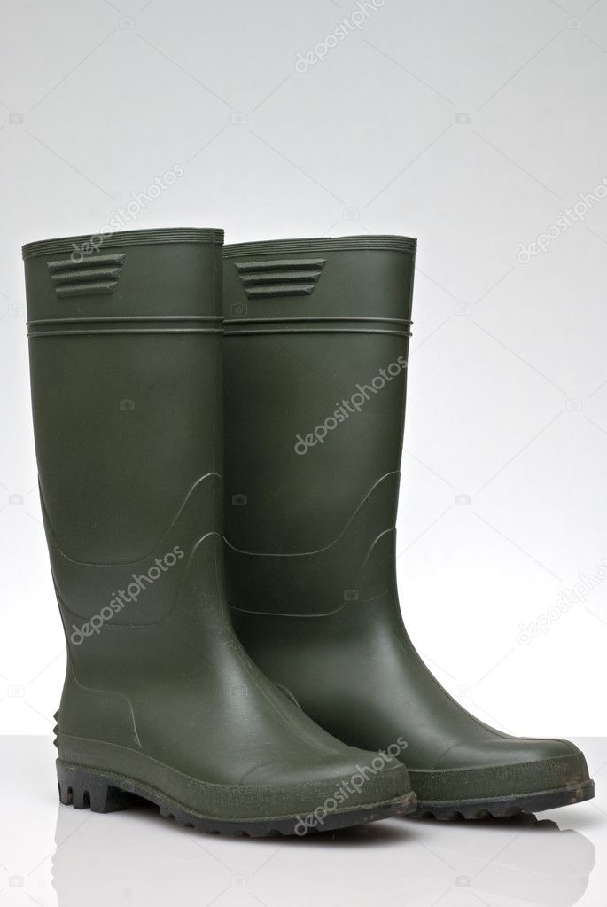 Green rubber boots isolated on white background.