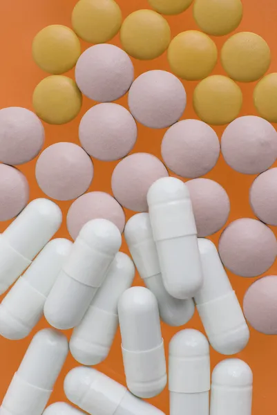 White, pink and orange pills — Stock Photo, Image