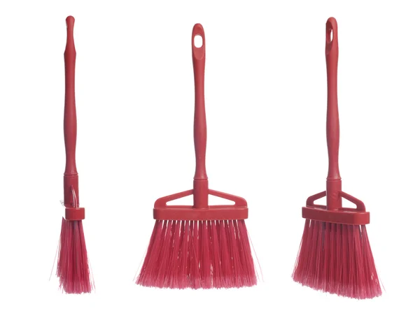 Three plastic red brooms — Stockfoto
