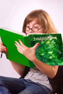 A girl reading a book about imagination clipart