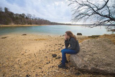 Girl thinking on beach clipart