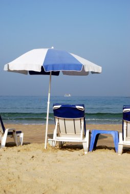 Umbrella in the sand at the seaside clipart