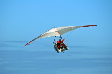 Hang glider boat flying over the Caribbean. clipart