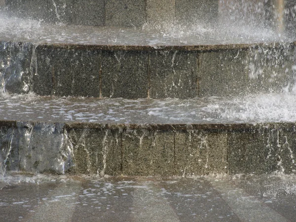 stock image The stream of water on the granite steps.Background.