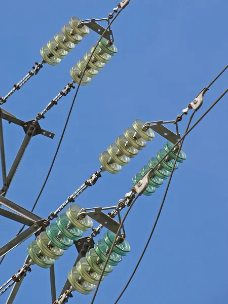 Stock image High voltage electrical insulator electric line against the blue sky.