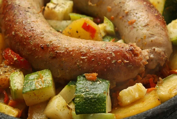 stock image Baked sausage meat with vegetables and spices