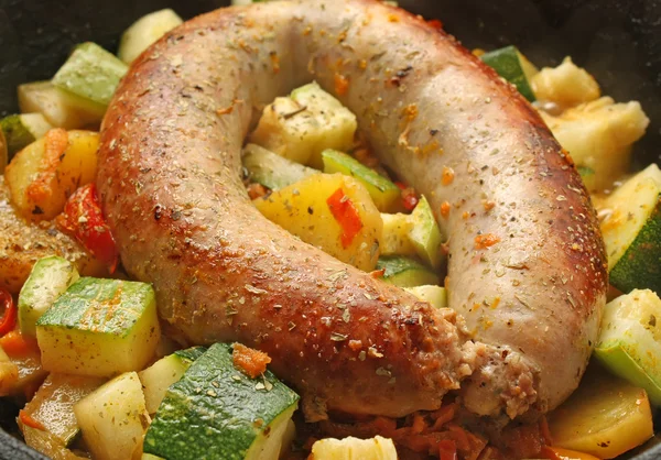 stock image Baked sausage meat with vegetables and spices