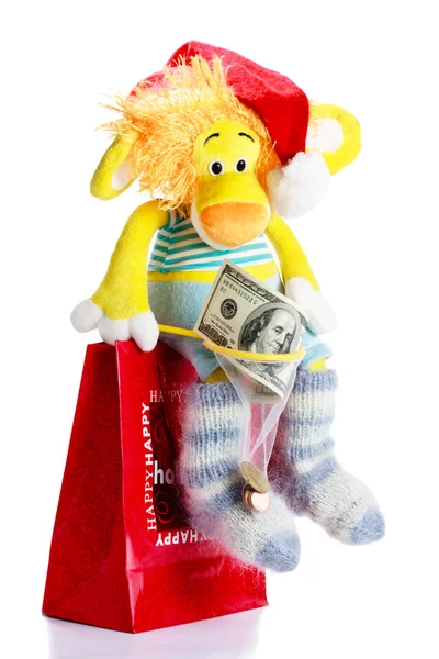 Toy lion as christmas gift on Santa Claus cap — Stock Photo, Image