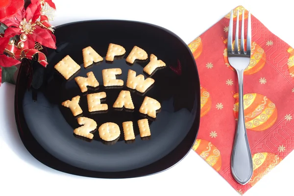 stock image Black plate with cookies, fork and christmas decoration