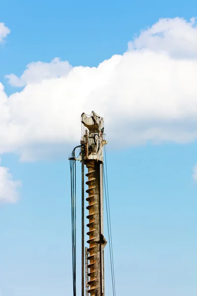 stock image Auger part over blue sky with clouds